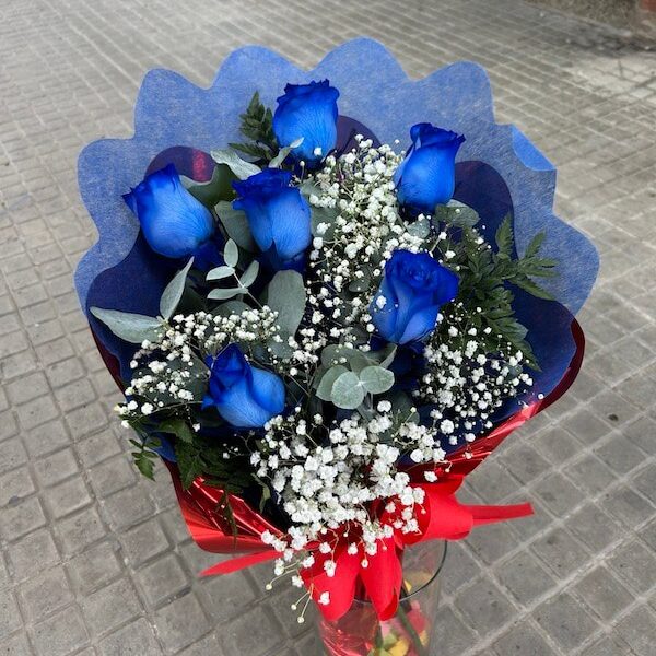 Ramo de rosas azules frescas envueltas en papel decorativo